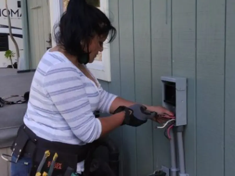 Licensed electrician wiring an exterior subpanel in Derby